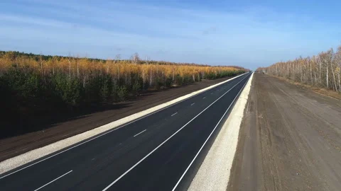 Aerial Flight over the road between fields Stock Footage 99251842