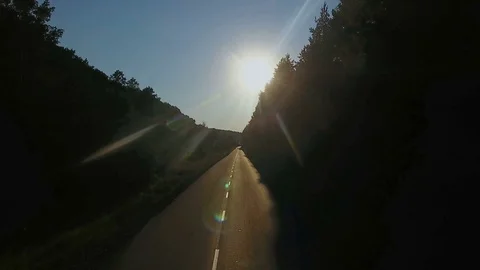 Aerial flight over the road between fields and beautiful forest Stock Footage 129793157
