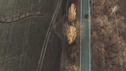 Aerial Flight over the road between fields. Spring colors and car driving Stock Footage 241012816