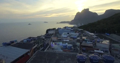 Aerial flight over the rooftops tilting upto a Favela. Rio De Janeiro, Brazil. Video stock 77749255
