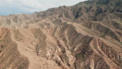 Aerial flight over the rugged and arid Skazka Canyon in Kyrgyzstan 動画素材 346298382