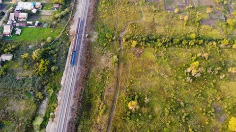 Aerial flight over a small train that travels by rail. Taken by drone at sunset Stock Footage 121166084