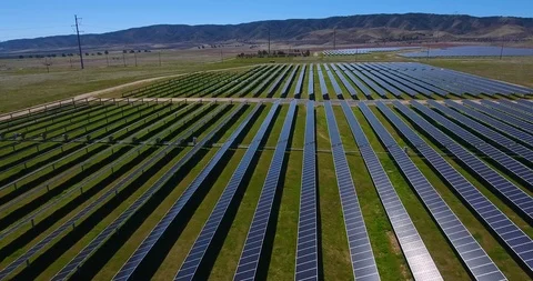 Aerial flight over solar panel fields in springtime Stock Footage 104812321