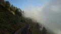 Aerial flight over sunny mountain road at clouds altitude 4k 4k or 4k+ Resolution