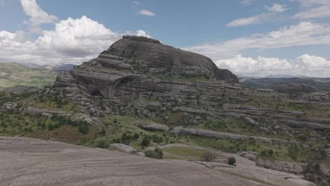 Aerial Flight Over Tree Revealing Massive Oval Rock Formation Stock Footage 344676341