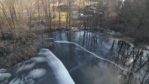 Aerial Flight Over Trees Onlooking Road Heading into Town during Winter (Par Stock Footage 314202239