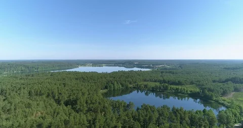 Aerial flight over two small lakes nestled in lush green forest in rural Euro Vídeo Stock 90951226