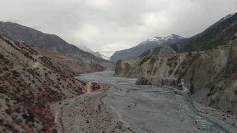 Aerial flight over valley going through a mountain pass. Video stock 134783609