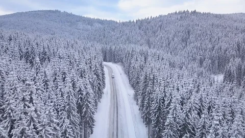 Aerial flight over winter forest with road Stock Footage 101601754