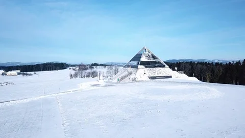Aerial flight over winter landscape with modern architecture pyramid Stock Footage 83569189