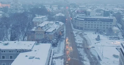 Aerial flight over winter Sofia with snowy buildings and boulevard Stock Footage 297786543