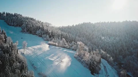 AERIAL: Flight Over Working Snow Makers and Frosted Winter Forest Stock Footage 140294168