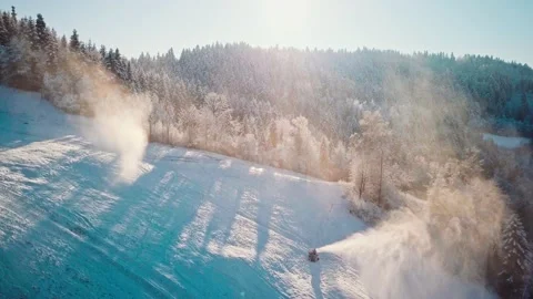 AERIAL: Flight Over Working Snow Makers and Frosted Winter Forest Vídeo Stock 140322451