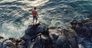Aerial Flight Over Young Man Jumping Off Ocean Sea Cliff Into Sunset. Stock Footage