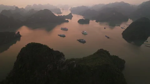 Aerial Flight Pan Sunset Ha Long Bay Limestone Karsts and Cruise Ships Hazy Stockbeeldmateriaal 335179934