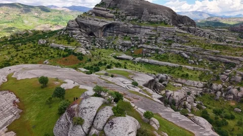 Aerial Flight Past Massive Rock Formations in Green Valley Stock Footage 344328440