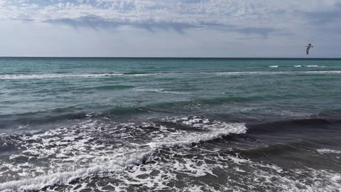 Aerial flight from a sandy beach over the Caspian sea waves, Mangystau Stock Footage 322791302