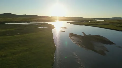 Aerial flight into setting sun over Tuul River on vast Mongolian steppe Stock Footage 345418361