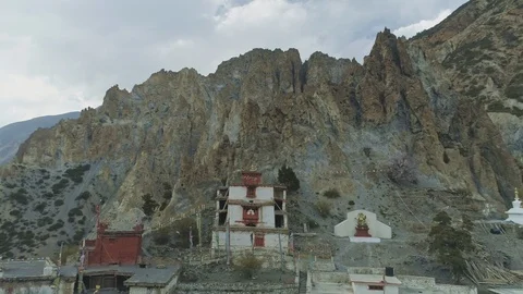 Aerial flight from sharp crest cliffs with old Braga monastery, Nepal Stock Footage 124679907