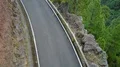 Aerial flight at small mountain road and wall with driving car in La Palma 4k 4k or 4k+ Resolution