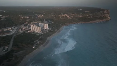 Aerial Flight from Sunset Toward Son Bou Coastal Resort, Menorca Stock Footage 344438316