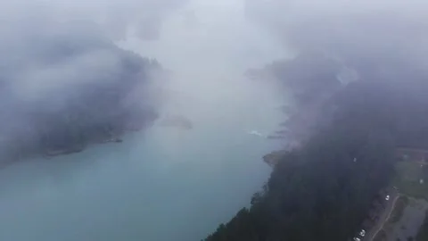 Aerial flight through the Clouds above the Forest and River Stock Footage 202106954