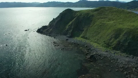 Aerial flight from top to bottom over an amazing small island Stock Footage 169494467