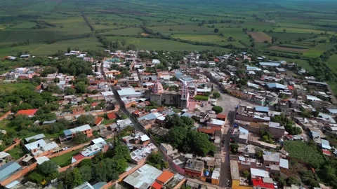 Aerial flight from a town out over open farmland Stock-Footage 342061966
