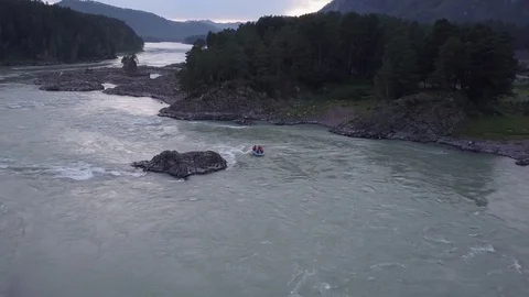 Aerial flight under mountain river Katun. Follow a boat with watermens. Altai. Video stock 84564373