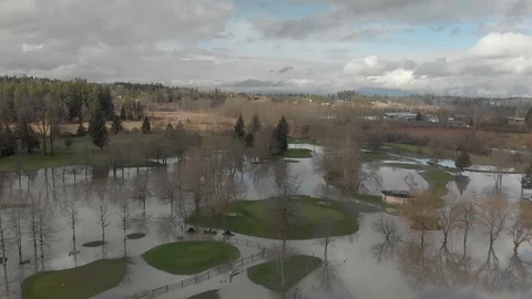 Aerial of flooded golf course after extreme rainfall Stock Footage