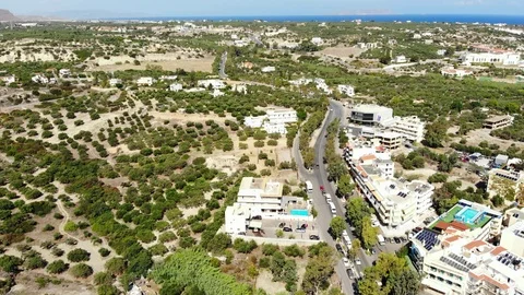 Aerial fly along road, olive groves, village and blue sea, Crete, Greece Stock Footage 101751374