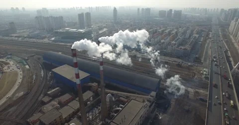 AERIAL FLY AROUND OF AIR POLLUTION - VERTICAL SMOKE STACKS - FACTORY IN CHINA Stock Footage
