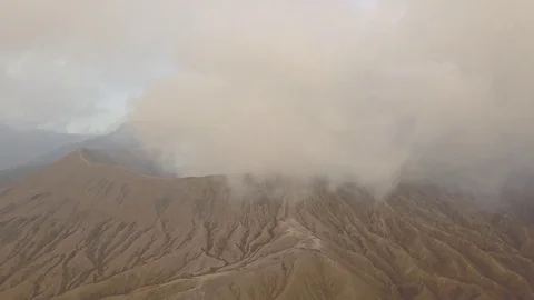 Aerial Fly back from volcano in clouds in Bromo Java Indonesia Stock Footage 82192572