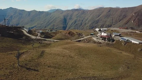 Aerial fly forward and downwards in Gudauri ski resort Stock Footage 117745299