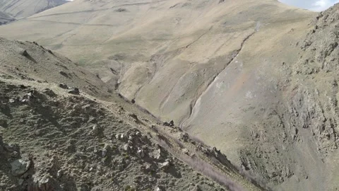 Aerial fly-forward shot into a rugged mountain gorge near Jily-Su Video stock 337023561