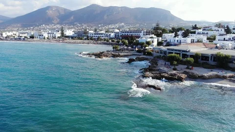Aerial fly up over beach, blue sea and hotels, Crete, Greece Stock Footage 101884762