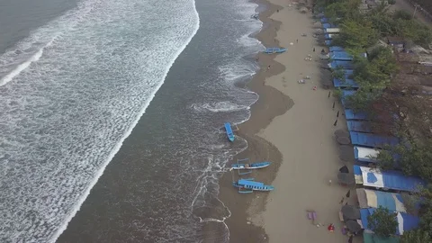 Aerial Fly over beach with waves and boats in Pangandaran Java Indonesia Stock Footage 84276375