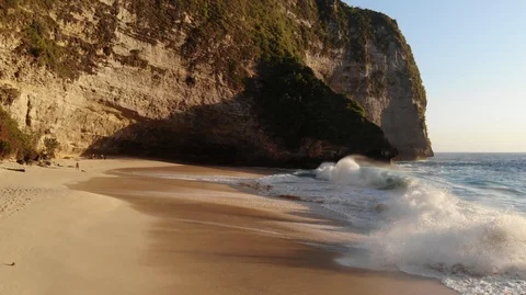 Aerial fly over big waves at Kelinking Beach on Nusa Penida Island Stock Footage 107870464