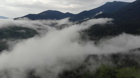 Aerial fly over clouds on rainy cloudy day on bagraunds  forest  and mountains Video stock 121072189