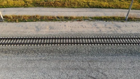 Aerial fly over empty railway tracks on the drone in the summer at sunset Stock Footage 123935532