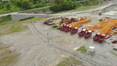 Aerial fly over empty trucks and tractors parked on ravel road in a field not Stockbeeldmateriaal 146510104