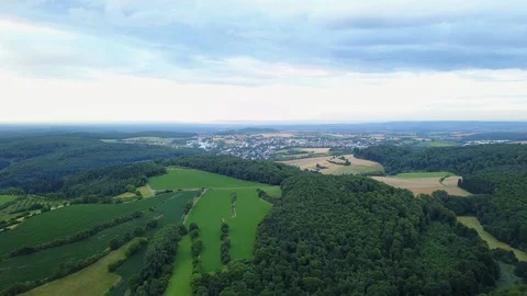Aerial fly over fields, forest and city in rural germany, europe Stock Footage 128744475
