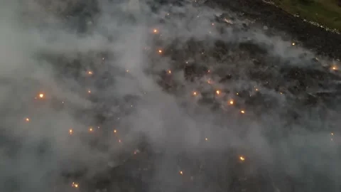 Aerial fly over fire burning at landfill | Stock Video | Pond5