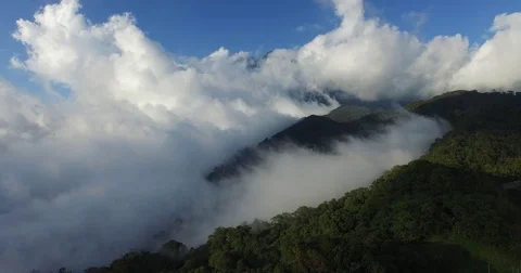 Aerial fly over forest mountain range and clouds, South East Asia Stock Footage 81337424
