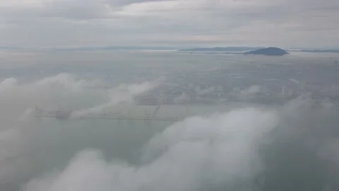 Aerial fly over low cloud. Background is container terminal Butterworth. Video stock 132965821