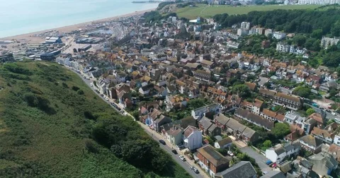 Aerial fly over the old town of Hastings in England and the beach Stock Footage 79928775