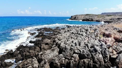 Aerial fly over rocky beach and blue sea, Crete, Greece Stock Footage 101164259