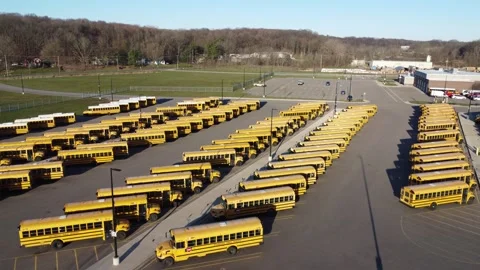 Aerial Fly Over of School Buses in Parking Lot Stock Footage 283509162