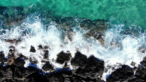 Aerial fly up over sea waves crashing on rocky beach, Crete Stock Footage 100824236