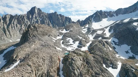 Aerial fly over shot of pristine alpine lake in Eastern Sierra mountain range Stock Footage 122859456
